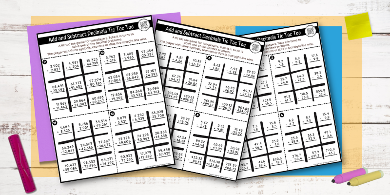 3 decimals tic tac toe worksheets on top of a desk.